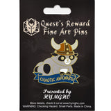 Pin with a design of a creature wearing a helmet on a black card with 'Quest's Reward Fine Art Pins' branding.