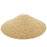 Pile of light brown sand on a white background