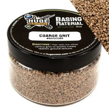 Jar of coarse grit material with 'Huge Miniatures' branding on a white background
