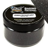 Huge Minis Basing Material jar with black lid and gray contents on a white background