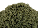 Close-up of a pile of green sand or gravel on a white background
