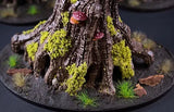 Wooden tree stump with moss and small mushrooms on a dark surface