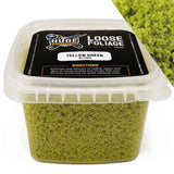 Container of yellow green loose foliage with a label on a white background