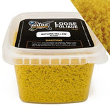 Container of autumn yellow loose foliage with a label on a white background