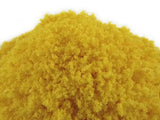 Close-up of yellow powder on a white background