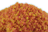 Close-up of a pile of red and yellow powder on a white background