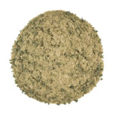 Round container of green seasoning mix on a white background