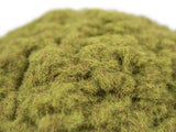 Close-up of a pile of green artificial grass on a white background