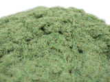 Close-up of green grass-like material on a white background