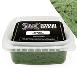 Container of static grass with a label on a white background