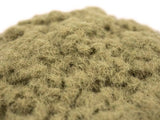 Close-up of a pile of green synthetic grass on a white background