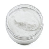 Clear jar with grayish-white cream on a white background