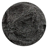 Close-up of a textured black stone with a circular border