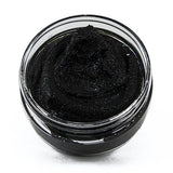 Black powder in a clear glass jar on a white background