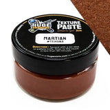 Jar of texture paste with black lid labeled 'Huge Minis Texture Paste' on a white background.