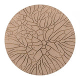 Round cork mat with a textured surface on a white background