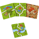 Set of board game pieces with village and landscape designs on a white background