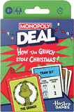 Monopoly Deal: How the Grinch Stole Christmas! card game package by Hasbro Games, featuring a green, blue, red, and white holiday-themed box with visible cards including The Grinch and Train Set.