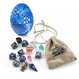 Blue dragon egg-shaped die, dice set, and drawstring bag on a white background