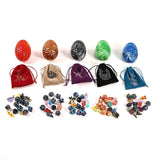 Set of colorful dice with matching drawstring bags on a white background