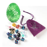 Green dragon egg, purple drawstring bag with dragon emblem, and various dice on a white background