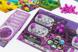Board game components including cards and hexagonal tiles on a colorful background