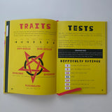 Open book showing pages titled 'Traits' and 'Tests' with a star symbol on a yellow background.