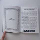 Open book with text on rules and problem-solving on a white background