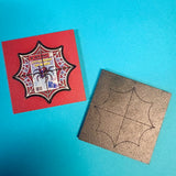 Spider web design patch on a red card with a brown paper template on a blue background