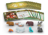 Board game components including cards and animal figures on a white background