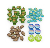 Collection of game pieces including green and brown tree tokens, blue and green flower tokens, and round blue and green tokens with animal illustrations on a white background.