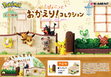 Pokémon figurine set with various characters in a display case, featuring Re-Ment branding.