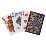 Four playing cards with ornate designs on a white background