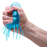 Hand holding a blue squid-shaped object against a white background