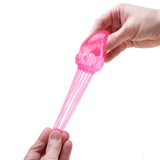 Pink hair tie with a skull design held by a hand on a white background