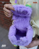 Purple fluffy bag held by a person with a blurred background