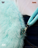 Close-up of a turquoise fluffy bag with a metal clasp, featuring Studio Pierrot branding.