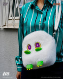 Person wearing a fluffy white bag featuring cartoonish eyes