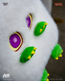 Close-up of a white plush toy bag with colorful eyes and feet on a blurred background.