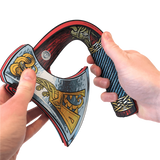 Decorative axe held by two hands with detailed design on a white background