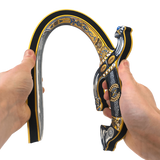 Decorative slingshot held by two hands on a white background