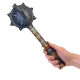 Decorative mace held by a hand on a white background