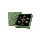 Set of dice with green box featuring geometric patterns on a white background