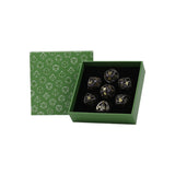 Set of dice with gold numbering in a green box with geometric pattern