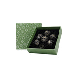 Set of silver dice in a green box with geometric pattern