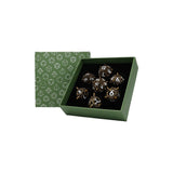 Set of dice with a green box and patterned lid on a white background