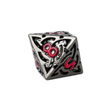 Decorative die with intricate patterns and red accents on a white background