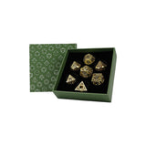 Set of gold dice with a green box featuring geometric patterns on a white background