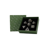 Set of dice with geometric designs in a green box on a white background