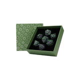 Green box with geometric pattern containing glowing green dice on a white background